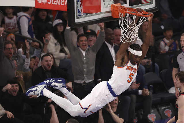 New York Knicks' Precious Achiuwa (5) hangs from the rim after dunking during the first half of an NBA basketball game against the Chicago Bulls, Thursday, February 20, 2025, in New York. (Photo by Pamela Smith/AP Photo)
