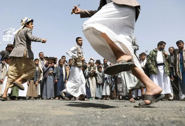Houthi supporters perform the Baraa dance during a rally marking the Ghadeer day, a day Shi'ites believe Prophet Muhammad nominated his cousin Imam Ali to be his successor, in Sanaa, Yemen on July 17, 2022. (Photo by Khaled Abdullah/Reuters)