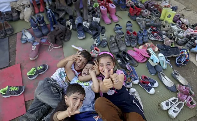 Migrant's childs pose at a collection point near the Serbian Hungarian border in Roszke, Hungary September 13, 2015. (Photo by Dado Ruvic/Reuters)