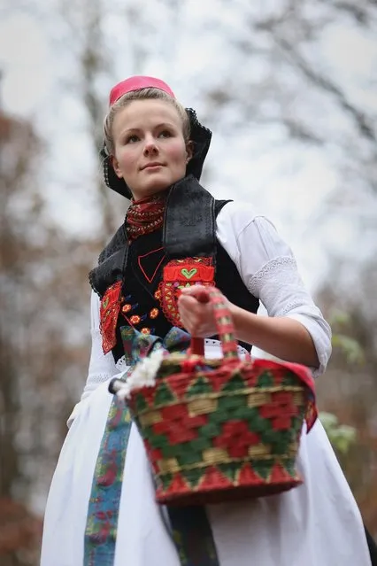 Little Red Riding Hood (in German: Rotkaeppchen, which translates to Little Red Cap), actually actress Dorothee Weppler, wears the local Schwalm region folk dress with its red cap as she walks through a forest on the estate of Baron von Schwaerzel on November 20, 2012 in Willingshausen, Germany. Little Red Riding Hood is one of the many stories featured in the collection of fairy tales collected by the Grimm brothers, and the two reportedly first came across the story while staying on the von Schwaerzel estate. The 200th anniversary of the first publication of Grimms' Fairy Tales will take place this coming December 20th. The Grimm brothers collected their stories from oral traditions in the region between Frankfurt and Bremen in the early 19th century, and the works include such global classics as Sleeping Beauty, Rapunzel, The Pied Piper of Hamelin, Cinderella and Hansel and Gretel.  (Photo by Sean Gallup)