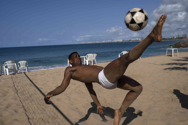 Nilson Nascimento plays footvolley on the beach in Salvador, Bahia state, Brazil, Friday, September 16, 2022. (Photo by Rodrigo Abd/AP Photo)