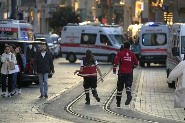Security and ambulances at the scene after an explosion on  Istanbul's popular pedestrian Istiklal Avenue, Sunday, November 13, 2022. Istanbul Gov. Ali Yerlikaya tweeted that the explosion occurred at about 4:20 p.m. (1320 GMT) and that there were deaths and injuries, but he did not say how many. The cause of the explosion was not clear. (Photo by Francisco Seco/AP Photo)