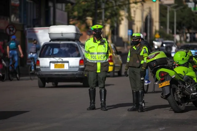 Members of the military forces in protective gear amid the new coronavirus pandemic patrol the streets, at the areas with a high number of COVID-19 cases in Bogota, Colombia, on July 16, 2020. The largest cities in Colombia return to a partial lockdown after a record week of COVID-19 cases, during the last week it has led the Latin American country to add 150,000 cases in total. Colombia is currently the fifth of the most affected countries in Latin America and more than 20% of all cases were registered in the last seven days, including a record of 6,803 new cases last Friday, according to data compiled by the Colombian Ministry of Health. (Photo by Juancho Torres/Anadolu Agency via Getty Images)