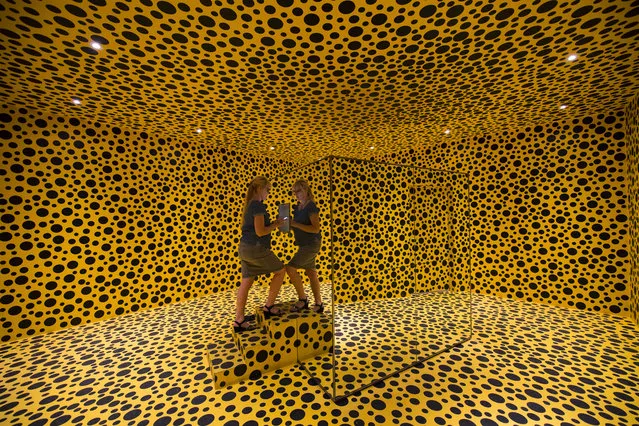 A visitor checks an art installation entitled “Mirror Room (Pumpkin)”, 1991, by Japanese artist Yayoi Kusama, part of the In Infinity art exhibition presented at the Moderna Museet, the Museum of Modern Art on August 31, 2016 in Stockholm. (Photo by Jonathan Nackstrand/AFP Photo)