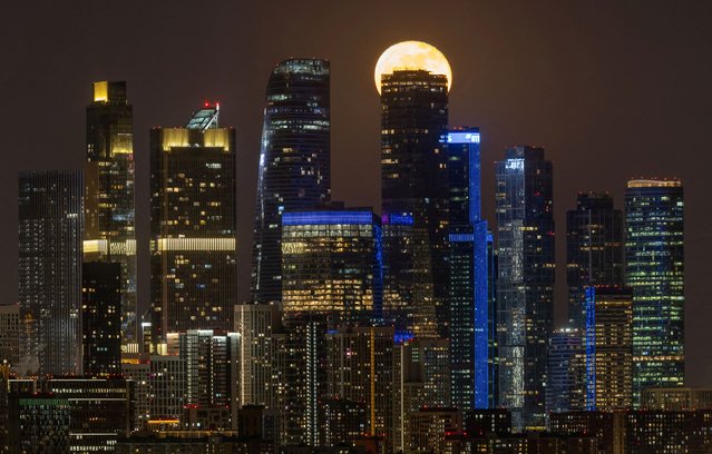 The moon rises behind a skyscraper of the Moscow International Business Centre in the city of Moscow, Russia on March 15, 2025. (Photo by Marina Lystseva/Reuters)