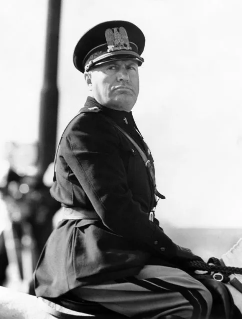 Benito Mussolini, in the newly introduced Fascist uniform, on his horse at a parade of police to commemorate the 13th anniversary of the foundation of the Metropolitan Police in Rome, Italy around October 20, 1938. (Photo by AP Photo)