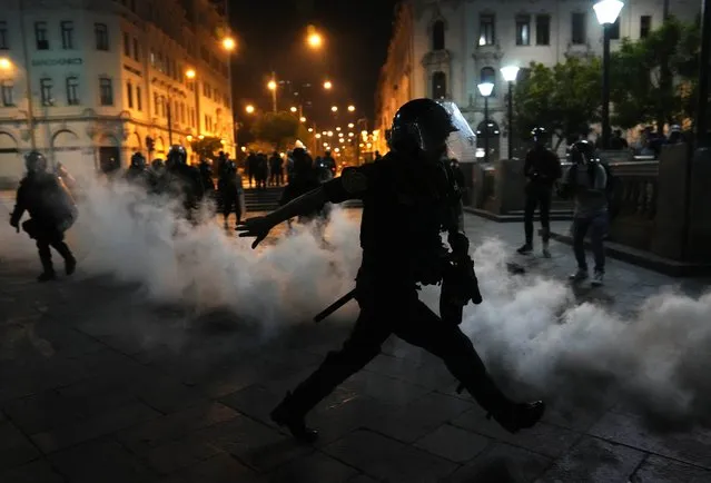 Tear gas is returned to police trying to break up supporters of ousted President Pedro Castillo at plaza San Martin in Lima, Peru, Sunday, December 11, 2022. Peru's Congress voted to remove Castillo from office Wednesday and replace him with the vice president, shortly after Castillo tried to dissolve the legislature ahead of a scheduled vote to remove him. (Photo by Martin Mejia/AP Photo)