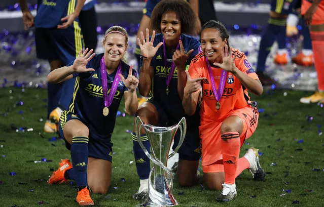 Lyon's Eugenie Le Sommer, Wendie Renard and goalkeeper Sarah Bouhaddi , from left to right, pose with the trophy after winning the Women's Champions League final soccer match between Wolfsburg and Lyon at the Anoeta stadium in San Sebastian, Spain, Sunday, August 30, 2020. Lyon won 3-1. (Photo by Clive Brunskill/Pool via AP Photo)