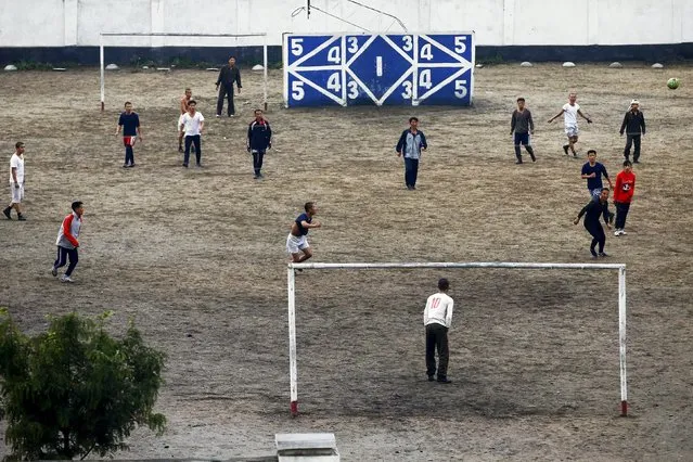 People play football in Pyongyang's suburbs, October 11, 2015. (Photo by Damir Sagolj/Reuters)