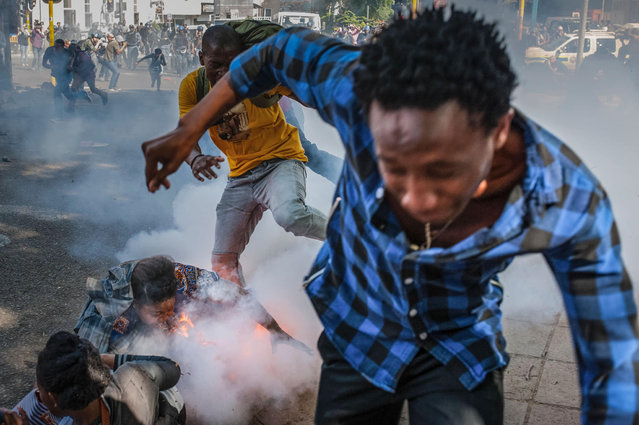 Students from the University of the Witwatersrand are injured by a police grenade during a protest against university fee increases on September 21, 2016 in Johannesburg, South Africa. South African police fired stun grenades and rubber bullets to disperse protesting students in central Johannesburg, in further outbreaks of unrest over higher tuition fees. (Photo by Daylin Paul/AFP Photo)