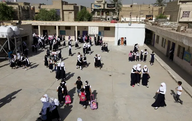 Students gather in their school yard on the first day of the new school term at a primary school in Baghdad, October 18, 2015. (Photo by Ahmed Saad/Reuters)