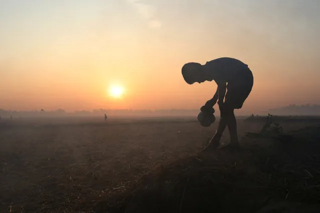 A Rohingya refugee boy washes his legs at sunrise at the Safari Bagan settlement near Teknaf, Bangladesh November 27, 2017. (Photo by Susana Vera/Reuters)