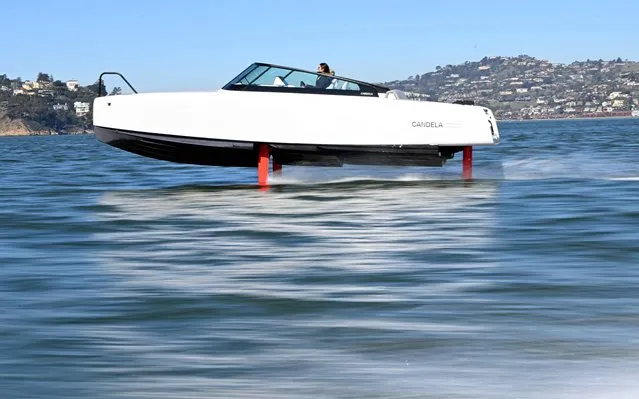 French sailor Tanguy de Lamotte, CEO of Candela US, drives the company's “flying” electric C-8 boat in Sausalito, California on February 8, 2023. What appears at a glance to be a simple pleasure hydrofoil rises above the water as it picks up speed in San Francisco Bay, grabbing the attention of ferry passengers. But this hydrofoil is different. For one thing, it makes very little noise because it is electric. “It's half plane and half boat; almost like riding a magic carpet”, French sailor Tanguy de Lamotte said from the helm of the 8.5-meter (28-foot) long C8. (Photo by Josh Edelson/AFP Photo)