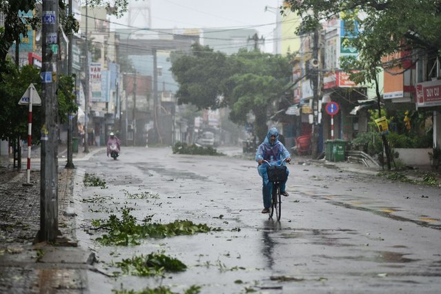 A man rides along a deserted road amid strong winds in central Vietnam's Quang Ngai province on October 28, 2020, as Typhoon Molave makes landfall. (Photo by Manan Vatsyayana/AFP Photo)