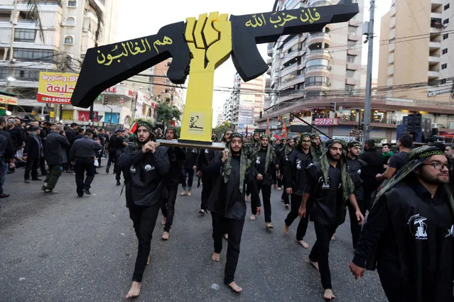 Lebanese Hezbollah supporters carry a replica of Hezbollah emblem during a religious procession to mark Ashura in Beirut's southern suburbs, Lebanon October 12, 2016. (Photo by Aziz Taher/Reuters)