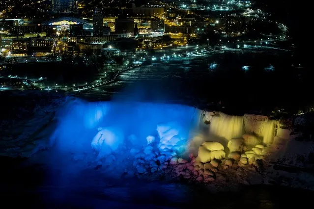 The American Falls and Bridal Veil Falls are lit in the colours of the Ukrainian flag, following the Russian invasion in Ukraine, as seen from Niagara Falls, Ontario, Canada on February 27, 2022. (Photo by Nick Iwanyshyn/Reuters)