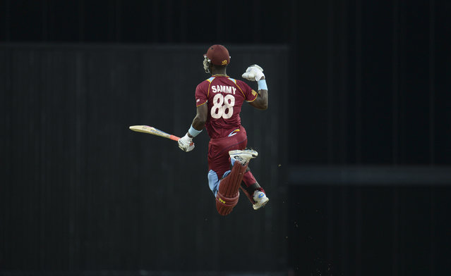 West Indies' Darren Sammy leaps to celebrate after the West Indies won their second T20 international cricket match against England at Kensington Oval in Bridgetown, Barbados March 11, 2014. (Photo by Philip Brown/Reuters)