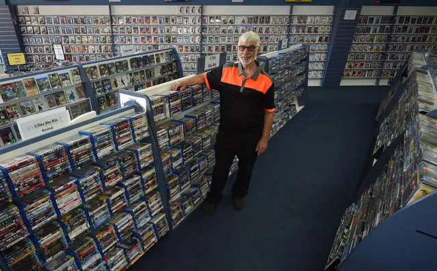 Geoffrey Hooper poses for a photograph in his DVD store in the western Sydney suburb of Mount Druitt on April 24, 2018. Hooper, 71, runs one of the last DVD stores in Sydney, as other outlets close their doors amid the shift towards streaming movies and television shows online. When Hooper first opened the store in 1993, the VHS tape format was still in vogue. (Photo by Peter Parks/AFP Photo)