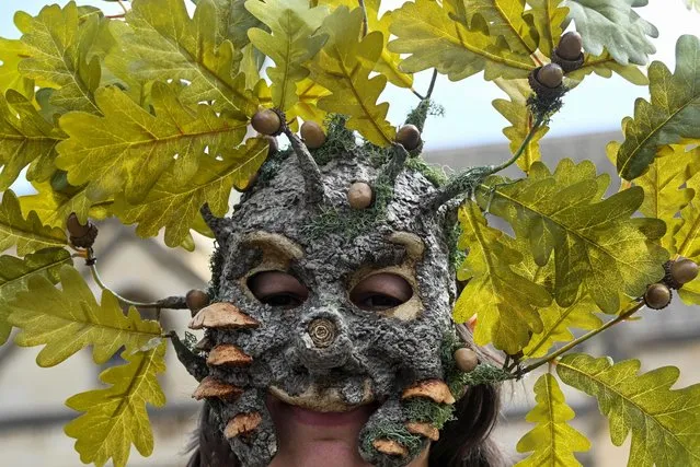 An activist from the Extinction Rebellion wears a mask, as they demonstrate as a part of “The Big One” event, in London, Britain on April 22, 2023. (Photo by Toby Melville/Reuters)