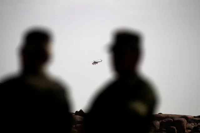 A helicopter belonging to the Minurso (U.N. mission in Western Sahara) flies over the Polisario second sector forward base on the outskirts of Tifariti, Western Sahara, September 9, 2016. (Photo by Zohra Bensemra/Reuters)