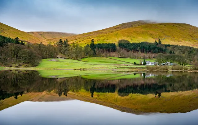 A calm morning view looking across the still tranquil water of Loch of the Lowes in the Scottish Borders, towards Riskinhope Farm with a perfect mirror image of the hilly landscape on April 17, 2023. (Photo by Phil Wilkinson/The Times)