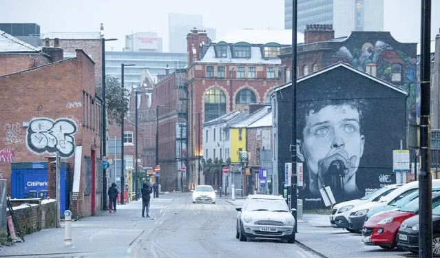 A mural of Joy Division's Ian Curtis watches over the Northern Quarter in Manchester city centre, as snow hits the UK. Tuesday 29th December 2020. (Photo by Pat Scaasi/MI News/NurPhoto via Getty Images)