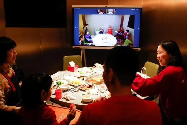 Liu Yuting and her family enjoy Lunar New Year dinner at a Haidilao hotpot restaurant with relatives in Jilin province via video link after they decided not to travel to their hometown following authorities' advice after a coronavirus outbreak in Beijing, China on February 11, 2021. (Photo by Carlos Garcia Rawlins/Reuters)