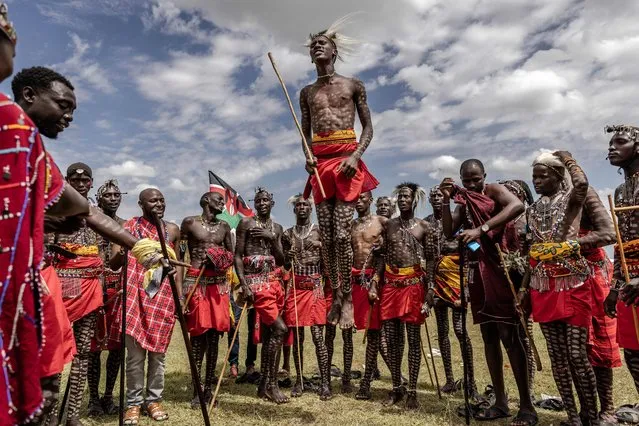 A group of Maasai men perform their traditional jumping dance during a Maasai cultural festival in Sekenani, on June 10, 2023. The Maasai people are a Nilotic ethnic group inhabiting Kenya and northern Tanzania. The Maasai cultural festival is a popular gathering and celebration of the Maasai cultural heritage and aims to showcase the community's traditional activities and fashion. (Photo by Luis Tato/AFP Photo)