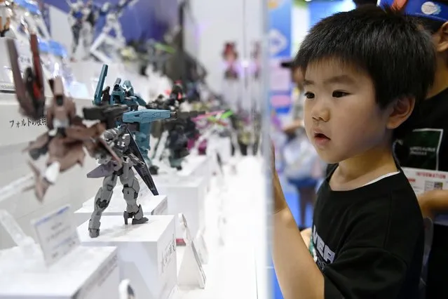 A child looks at toys as on the last public day of the International Tokyo Toy Show at the Tokyo Big Sight convention center in Tokyo, Japan on June 11, 2023. The Tokyo Toy Show is held for four days from June 8-9 for buyers and from June 10-11 for fans, enthusiasts and Japanese families. (Photo by David Mareuil/Anadolu Agency via Getty Images)