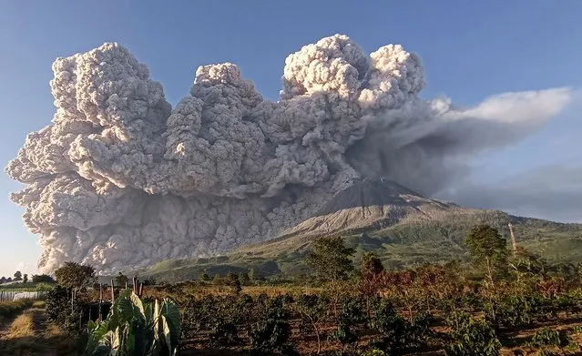 Mount Sinabung spews some 5,000-metre-high of hot ash into the sky seen from Karo, North Sumatra on March 2, 2021. (Photo by Sastrawan Ginting/AFP Photo)