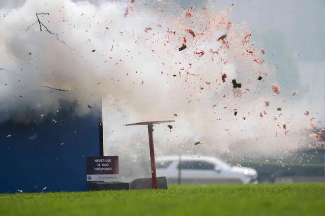 Debris is scattered up in the air during a demonstration on the dangers of highly explosive fireworks if not used safely on the National Mall in Washington, Thursday, June 29, 2023. The U.S. Consumer Product Safety Commission advised not to use this kind of fireworks. (Photo by Manuel Balce Ceneta/AP Photo)