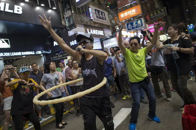 Buskers performing in Sai Yeung Choi Street South in Mongkok district, Hong Kong, China, 29 July 2018. (Photo by Jerome Favre/EPA/EFE)