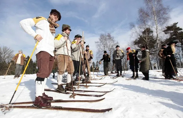 Participants wearing vintage dresses prepare for a traditional historical ski race in the northern Bohemian town of Smrzovka February 21, 2015. (Photo by David W. Cerny/Reuters)