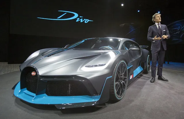 President of Bugatti Automobiles S.A.S. Stephan Winkelmann gestures as he speaks next to a 5 million euro (5.8 $) Bugatti Divo during a media presentation on the eve of Paris Auto Show in Paris, Monday, October 1, 2018. Doubts about diesel, Brexit, trade worries, tighter emissions controls. Those are the challenges that will be on the minds of auto executives when they gather this week ahead of the Paris Motor Show at the Porte de Versailles exhibition center. (Photo by Michel Euler/AP Photo)