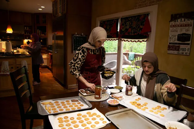 Patul and Ayah Kutmah make sweets the day before Eid at their home in Louisville, Kentucky, U.S. on May 11, 2021. (Photo by Amira Karaoud/Reuters)