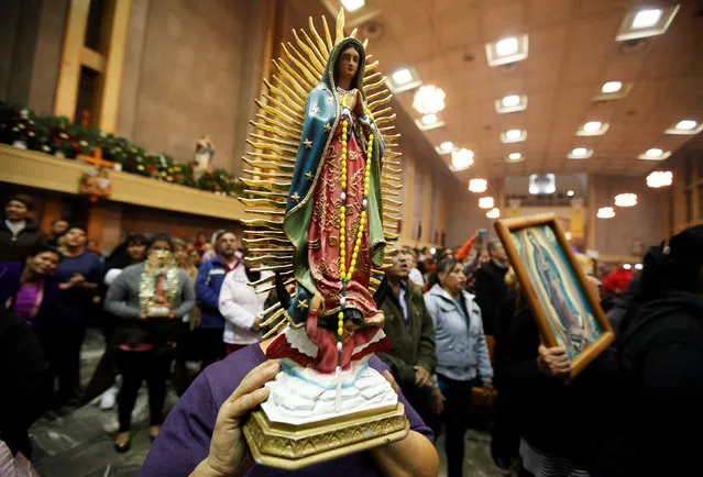 A pilgrim carries a statue of Mexico's patron saint the Virgin of Guadalupe during the annual pilgrimage in honor of the virgin in Ciudad Juarez, Mexico December 12, 2016. (Photo by Jose Luis Gonzalez/Reuters)
