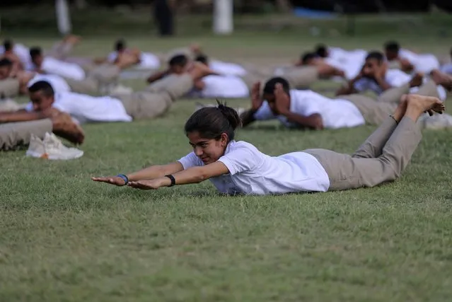 Special police officer recruits who completed nearly three months physical training perform yoga at Kathua in Indian-controlled Kashmir, Saturday, June 5, 2021. (Photo by Channi Anand/AP Photo)