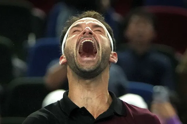 Grigor Dimitrov of Bulgaria celebrates after defeating Carlos Alcaraz of Spain in the 4th round of the men's singles match in the Shanghai Masters tennis tournament at Qizhong Forest Sports City Tennis Center in Shanghai, China, Wednesday, October 11, 2023. (Photo by Andy Wong/AP Photo)