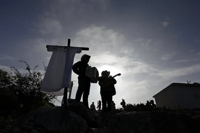 Musicians are silhouetted at the Cerro de la Campana (or hill of the bell) during celebrations for El Nino Fidencio in the town of Espinazo, on the outskirts of Monterrey March 19, 2015. (Photo by Daniel Becerril/Reuters)