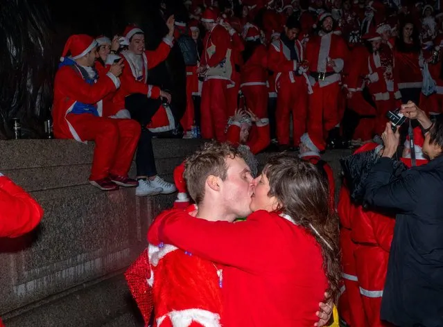 Santas gather in Trafalgar Square to celebrate Christmas on December 8, 2018 in London, England. SantaCon is an annual pub crawl featuring revelers dressed as Santa, reindeer and other Christmas icons. Originating in the United States, it has spread to several international cities, developing a reputation for rowdy crowds. (Photo by Peter Dench/Getty Images)