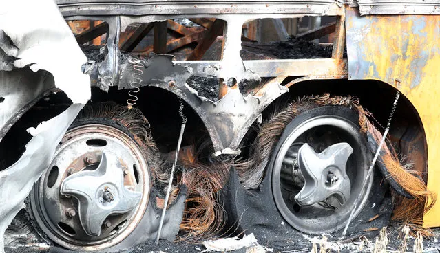 The burned wheels of a music band tour bus sit in a garage in Fortaleza, Brazil on January 10, 2019. (Photo by Paulo Whitaker/Reuters)