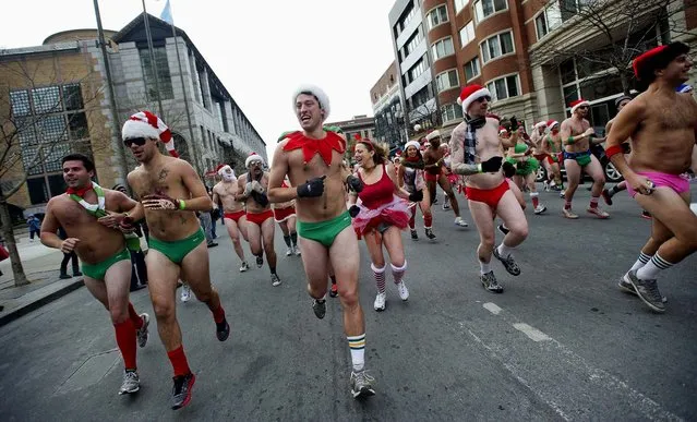 Participants in the annual “Santa Speedo Run” dash through the streets of the Back Bay neighborhood of Boston. (Photo by Gretchen Ertl/Reuters)
