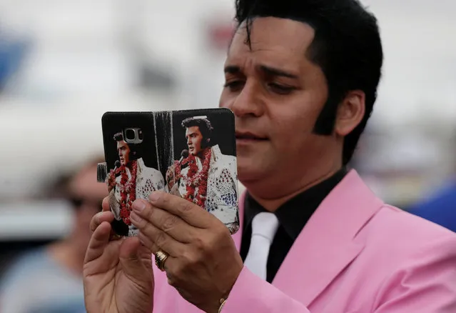 Elvis Presley tribute artist Stuart Vieyra takes a picture with his camera phone during a street parade at the 25th annual Parkes Elvis Festival in the rural Australian town of Parkes, west of Sydney, January 14, 2017. (Photo by Jason Reed/Reuters)