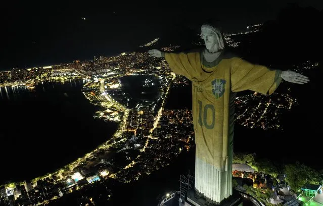 Aerial view showing an image projected onto the Christ the Redeemer statue pays tribute to Brazilian football legend Pele on the first anniversary of his death, at Corcovado Mount in Rio de Janeiro, Brazil, on December 29, 2023. (Photo by Mauro Pimentel/AFP Photo)
