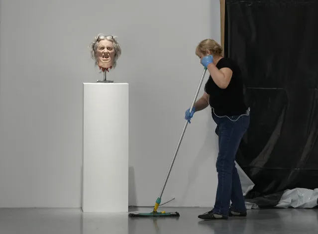 A worker cleans near an exhibit by Danish conceptual artist Kristian von Hornsleth at the Ujazdowski Castle Center for Contemporary Art in Warsaw, Poland, Wednesday August 25, 2021. (Photo by Czarek Sokolowski/AP Photo)