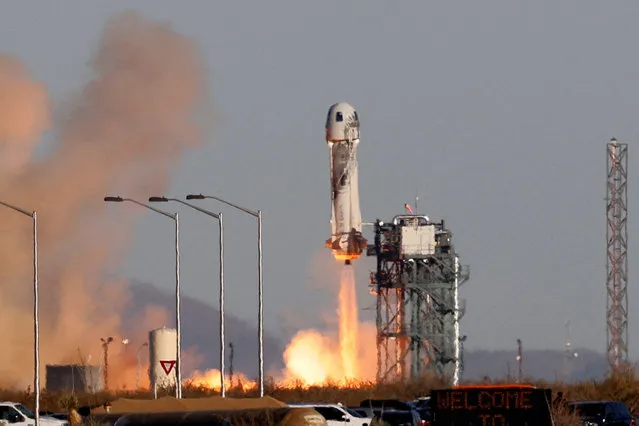 A Blue Origin New Shepard rocket lifts off with a crew of six, including Laura Shepard Churchley, the daughter of the first American in space Alan Shepard, for whom the spacecraft is named, from Launch Site One in west Texas, U.S. December 11, 2021. (Photo by Joe Skipper/Reuters)