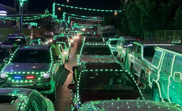 Mosques, vehicles and buildings are illuminated with green lights during Mawlid al-Nabi celebrations in Sanaa, Yemen on September 25, 2023. (Photo by Mohammed Hamoud/Anadolu Agency via Getty Images)