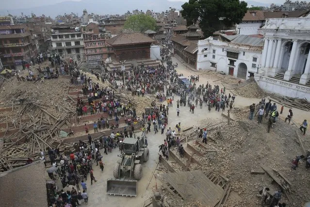 People search for survivors under the rubble of collapsed buildings in Kathmandu Durbar Square, after an earthquake caused serious damage in Kathmandu, Nepal, 25 April 2015. (Photo by Narendra Shrestha/EPA)