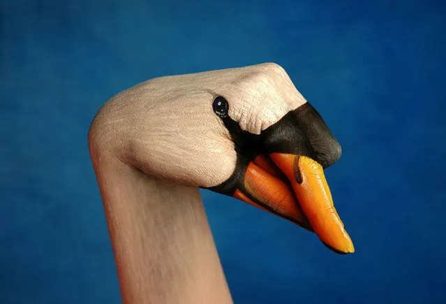 Models poses with their arm after it was painted by body artist Guido Daniele