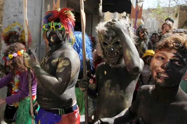 Residents perform during the annual Zambo carnival, in the coastal city of Tripoli, northern Lebanon March 13, 2016. Revellers would paint their bodies, put on costumes and parade in the streets of Tripoli during the carnival before the start of the Christian fasting season in the lead up to Easter. (Photo by Omar Ibrahim/Reuters)